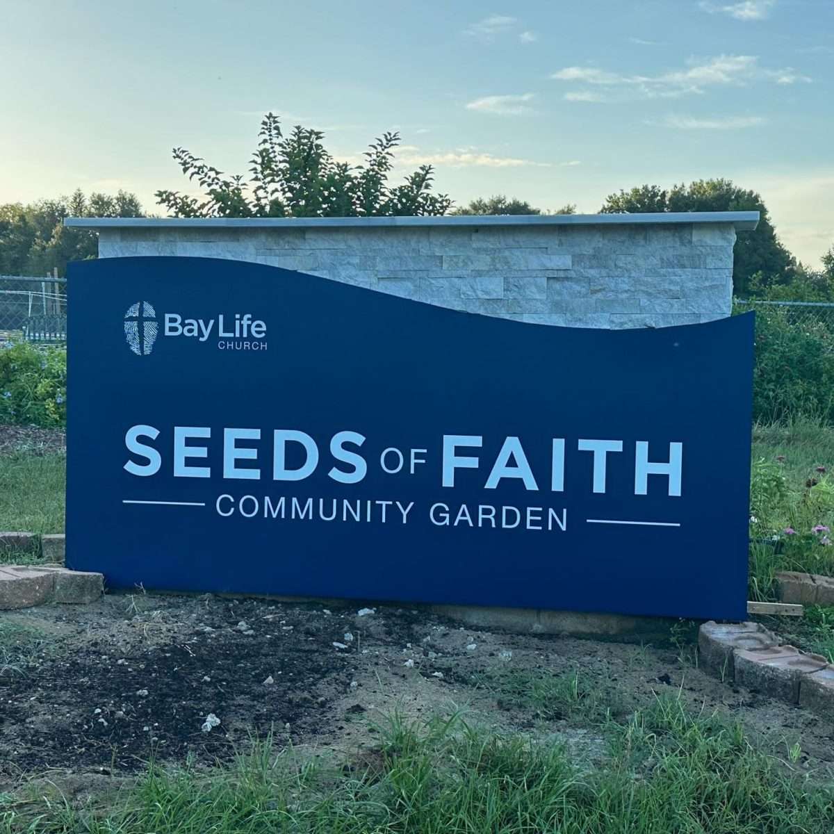Seeds of Faith Community Garden with thriving vegetables and plants, dedicated to providing fresh produce for local food pantries.